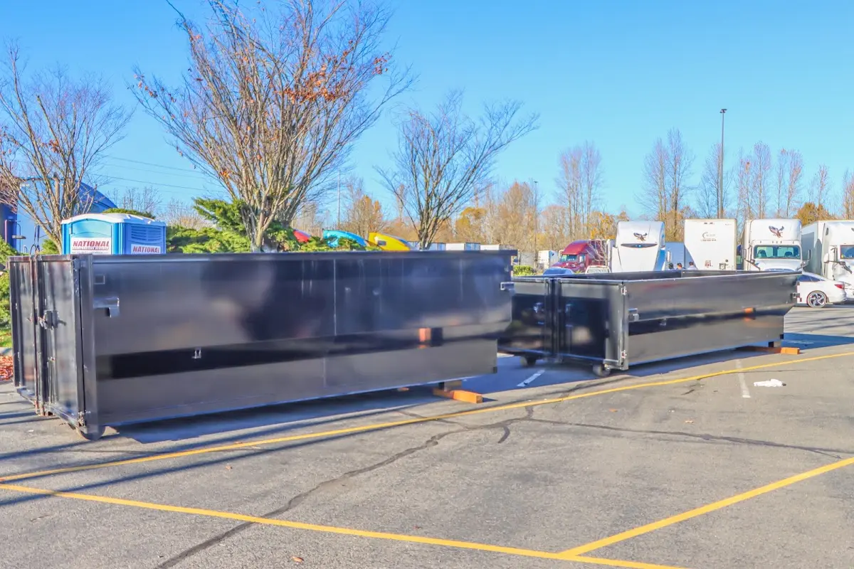 Professional dumpster rental service with roll-off container on residential driveway in Fair Oaks